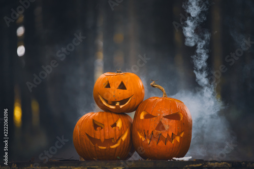 Atmospheric photo of halloween pumpkins in autumn forest