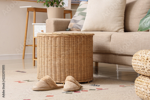 Cozy home lifestyle and relaxation, pair of soft slippers on rug near wicker ...