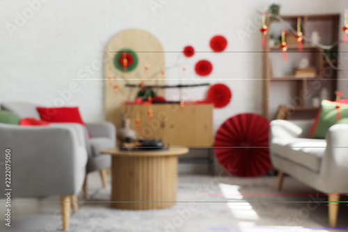 Blurred view of living room with sofa, armchairs and decor for Chinese New Ye...