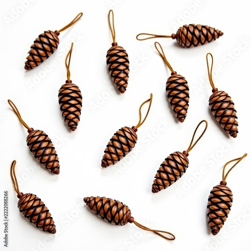 Natural pinecone ornaments with twine loops scattered on white background for holiday decoration and craft inspiration