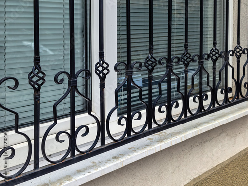 Wrought iron security bars on residential window exterior
