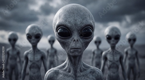 Group of gray extraterrestrial beings with large black eyes standing beneath a dramatic cloudy sky, depicting an alien encounter and science fiction mystery.