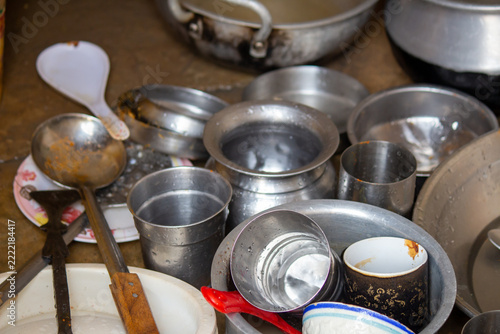 Used metal kitchen utensils gathered together before washing and cleaning