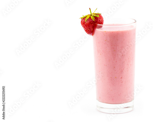 Pink strawberry smoothie served in a tall clear glass with a fresh ripe berry garnish, isolated on a white background for a clean food and drink concept