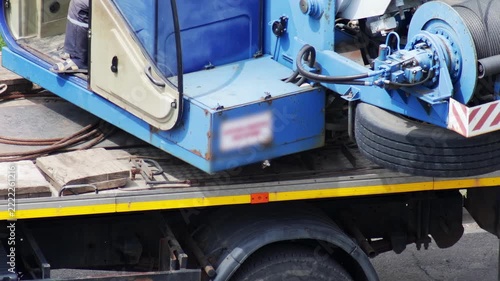 Truck crane with a platform, rotating the mechanism for lifting the load, slow motion.