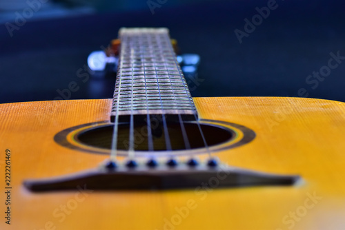 Obraz na plátně Close-up macro shot of an acoustic guitar bridge, sound hole, and fretboard with tight strings, representing musical instruments, acoustic sound, and melody performance