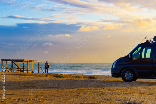 Camper van on beach at sunrise
