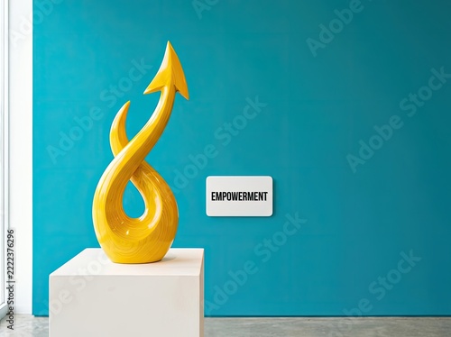 Yellow upward arrow sculpture on pedestal ideal for business leadership media symbolizing personal growth achievement and team empowerment