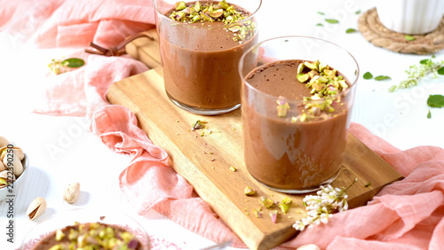 A close-up of chocolate mousse with pistachios and a spoon