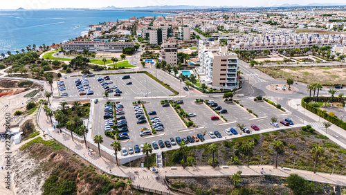 Aerial view of coastal parking lot and resort town