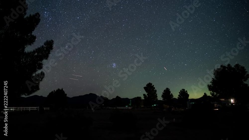 Night time lapse of stars rising over a campground