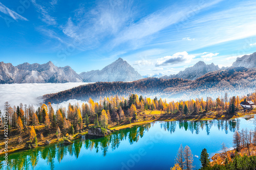 Amazing  aerial view of  crystal clear Lake Federa in Dolomites Alps under sunlight in mist and fog.