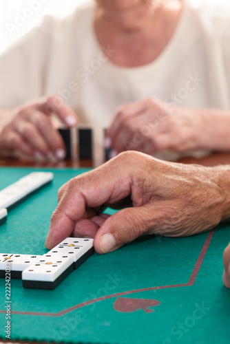 Elderly couple enjoying dominoes game together