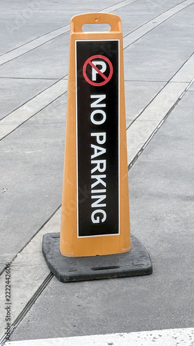Portable No parking sign on urban pavement and roadway