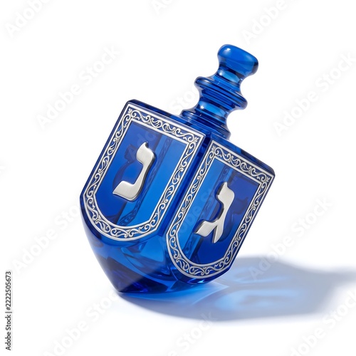 Blue glass dreidel featuring silver filigree and Hebrew lettering.