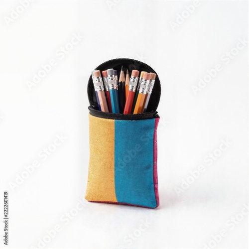 Colorful fabric pencil case with pencils on white background