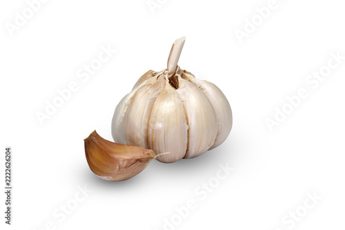 Whole garlic bulb with single clove beside it