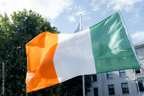 Irish flag waving outdoors in Dublin under sunny sky