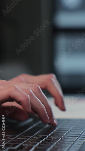 Vertical video. Woman hands professional user using typing on laptop notebook keyboard at home. Female fingers tapping and texting on computer browsing.