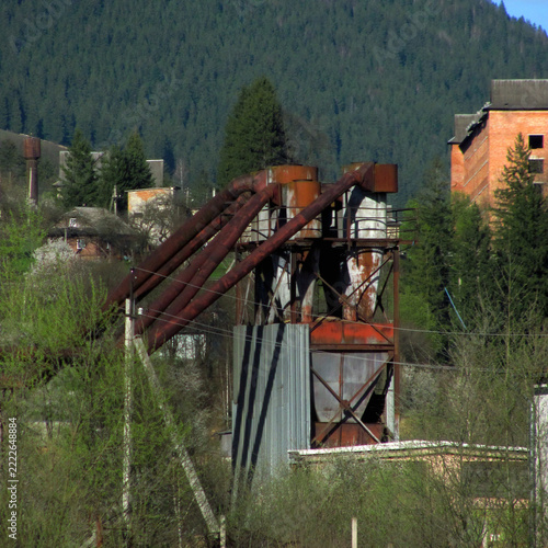 Rusty industrial pneumatic cyclone dust collector for saw dust extraction outdoors
