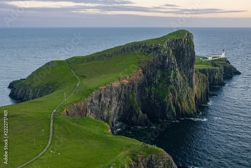 Scenic coastal view of the historic Neist Point Lighthouse on the rocky cliffs of the Isle of Skye, Scotland
