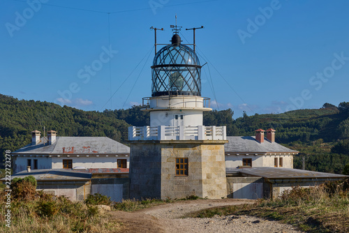 Front view of historic Estaca de Bares lighthouse and buildings in Galicia Spain