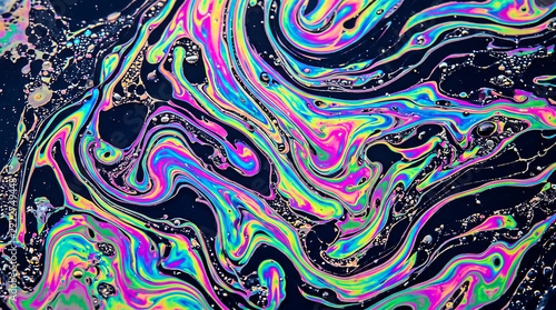 Iridescent oil slick patterns with neon pink, cyan, and violet swirls on a dark background, suitable for futuristic graphic design and digital art concepts