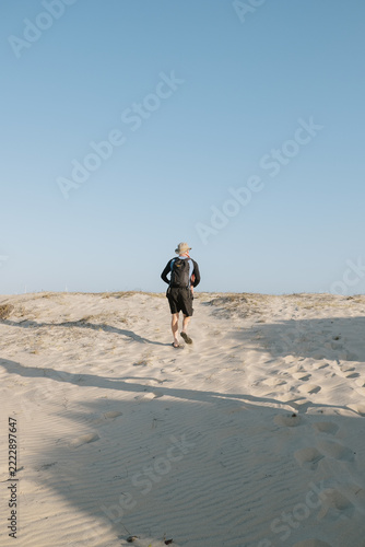 Traveler walking on the sand dunes in Ceará, Brazil