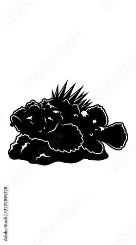 Silhouette of a prickly fish on a rock.