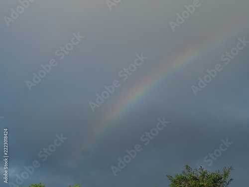 Faint Rainbow Emerging Through a Cloudy Sky