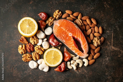 Focus on vitamin D and vitamin B in food sources with salmon, nuts, and lemon in a kitchen setting