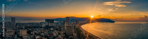 Sunrise over Quy Nhon, Vietnam, from aerial level looking toward the coastline. Peaceful tropical coastal landscape panorama