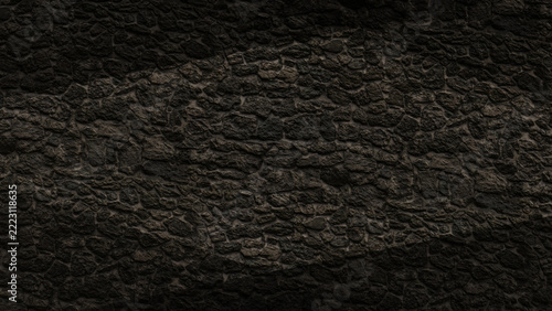 Dark brown stone wall texture background with subtle diamond lighting in masonry pattern