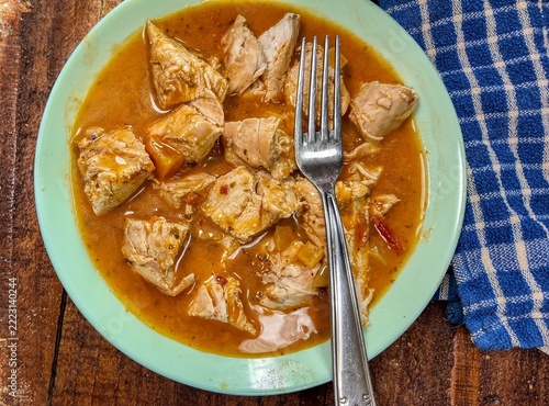 butter chicken  in a bowl with a fork