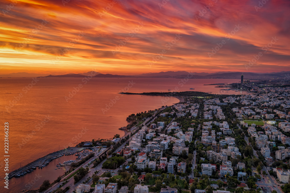 Fototapeta premium Aerial view of the southern coast of Athens, Greece, with Voula district, boat marinas and beaches during a colorful sunset