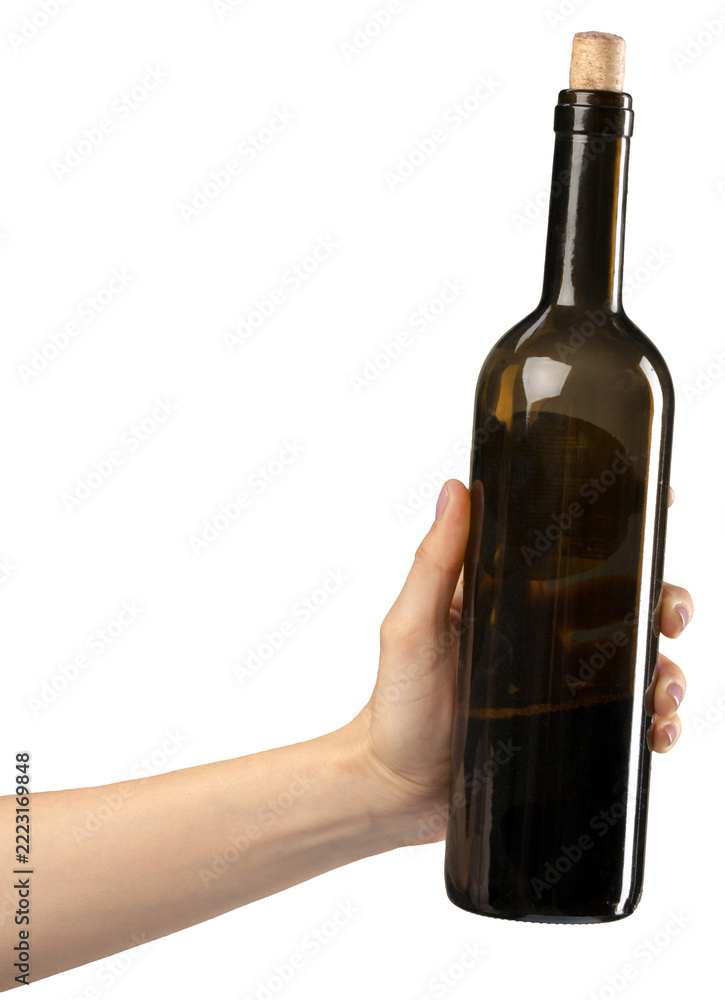 Fototapeta premium Hand holding a dark glass wine bottle with a cork in an indoor setting