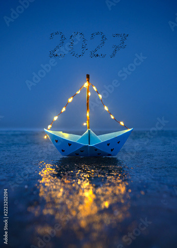 lantern paper boat on the sea for start in the year 2027