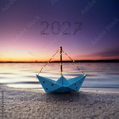 Handmade Paper Boat on the Beach with 2027 Symbolizing New Year and Fresh Beginnings