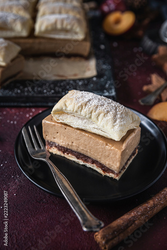 Plum cream cake slice with caramel and flaky pastry