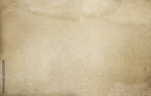 Spotted dirty old paper background in a grunge style.