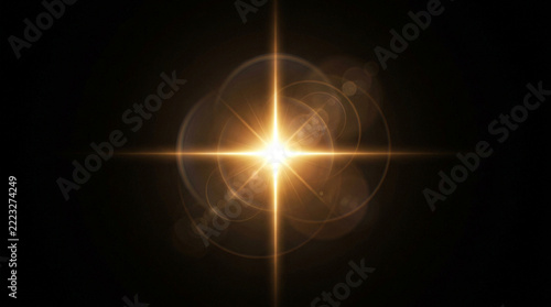 Bright golden starburst light flare effect with lens circles isolated on a deep black background