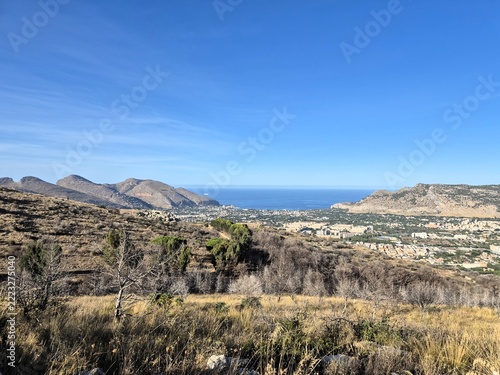  Panoramic mountain viewpoint overlooking valleys, hills, urban settlements and the Mediterranean coastline. Expansive landscape showcasing the natural beauty of Italy.
