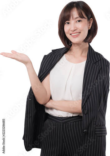 Happy asian woman pointing open palm presenting black friday sale promotion offer with cheerful smile isolated transparency background studio shot for commercial advert advertising copy