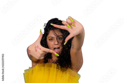 Playful woman creating finger frame on blue background