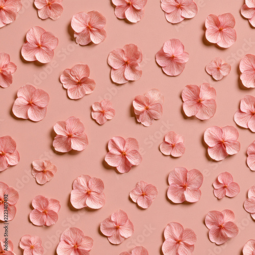 Seamless pattern, tiny hydrangea florets scattered evenly, muted dusty pink background, minimal 2D botanical, clear sharp edges, scrapbooking paper print