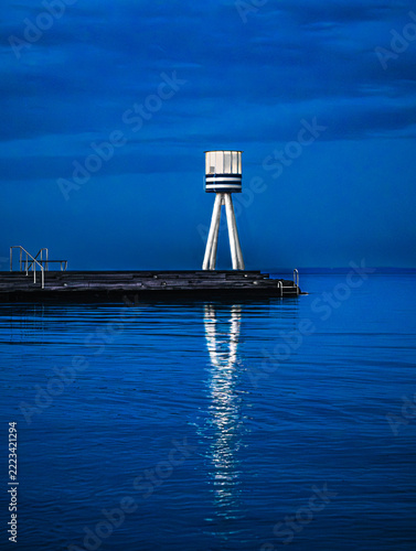 Illuminated Coastal Beacon Reflecting Twilight
