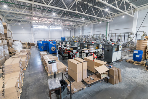 Large manufacturing area with machines and boxes in a spacious facility