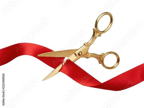 A pair of gold scissors cutting through a red ribbon on transparent background
