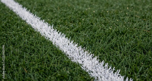 White Painted Boundary Line On Green Grass Sports Field