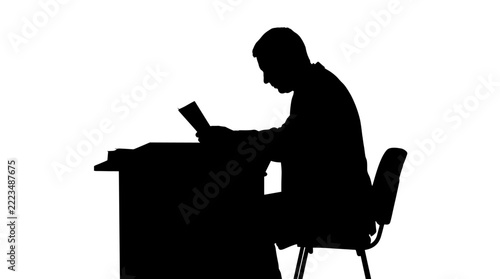 Office worker silhouette reading documents at professional desk.